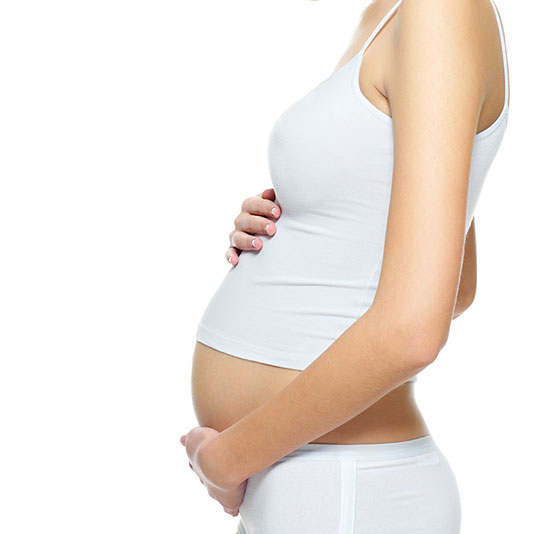 OB-GYN Services. Beautiful pregnant young happy woman
